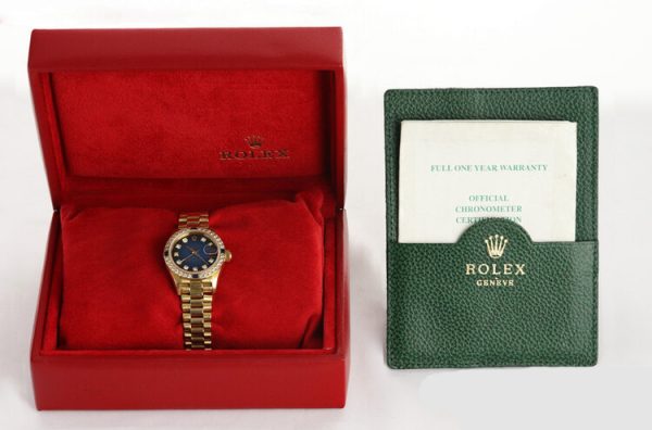 Rolex Oyster Perpetual Lady-Datejust 69088 in 18ct Yellow Gold with Original Diamond Dial and Bezel, Blue Vignette Serti dial, automatic movement, 18ct President bracelet with Crownclasp, with Rolex box and papers