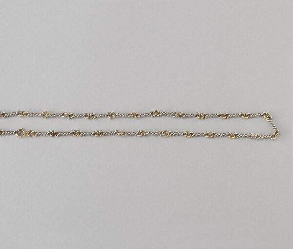 Chaumet Vintage 18ct Yellow Gold and Silver Chain; gold round links alternated with twisted silver links. Signed and numbered, Circa 1970