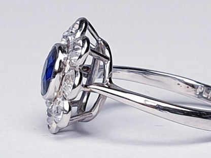 Vintage Sapphire and Old Cut Diamond Flower Cluster Ring; central 0.75 carat natural royal blue sapphire surrounded by 1.40cts old cut diamonds, on a new platinum shank