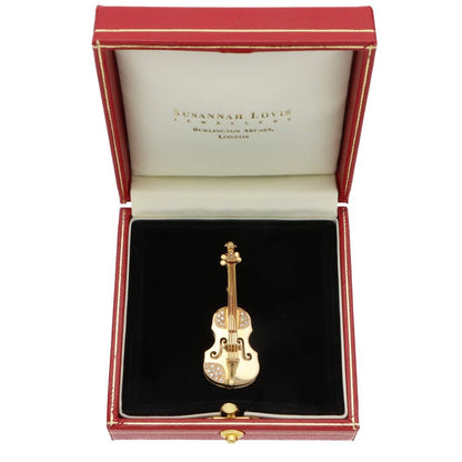 Diamond violin brooch in yellow gold.