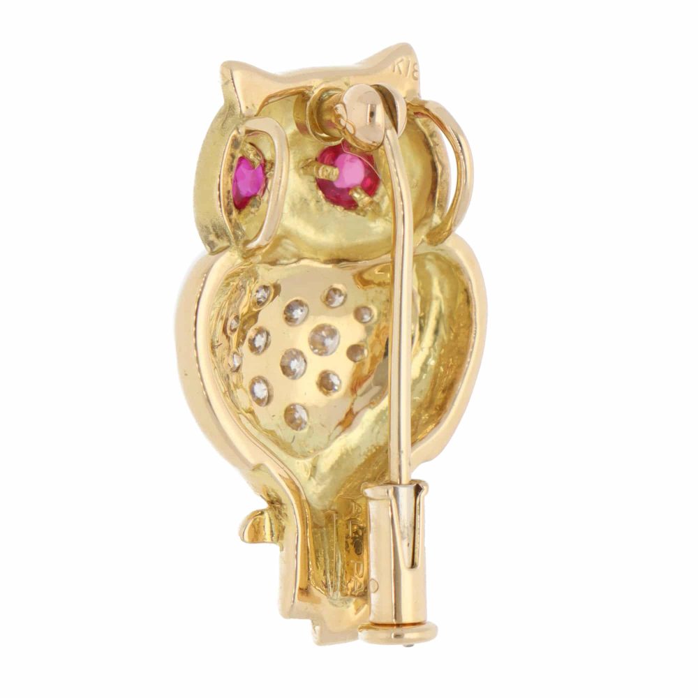 A vintage diamond and ruby owl brooch made in 18ct yellow gold
