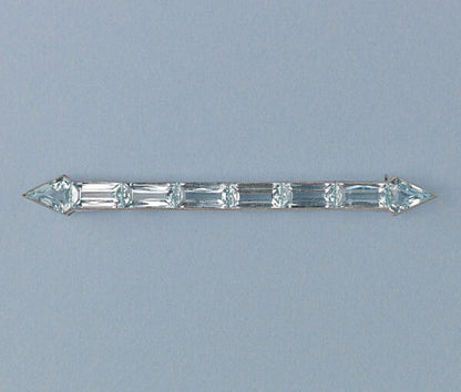 Art Deco Aquamarine Arrow Bar Brooch; baguette-cut and diamond-shaped aquamarines mounted in platinum, arrow design, on a yellow gold pin.