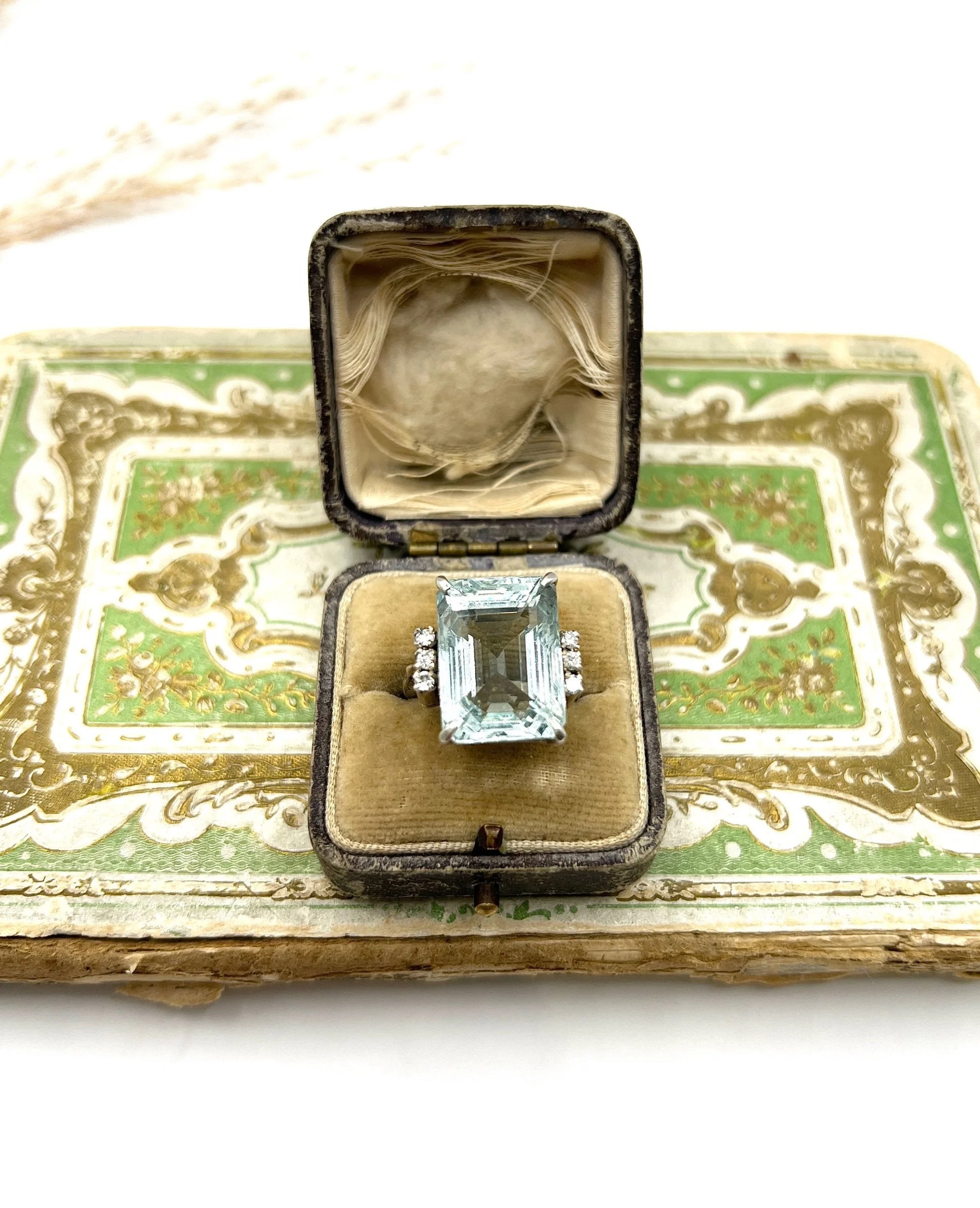 An aquamarine and diamond cocktail ring in white gold, in an antique ring box
