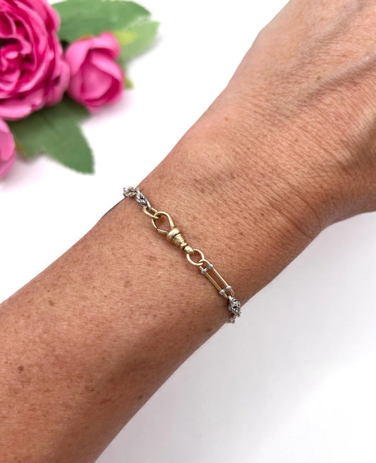 A yellow gold and platinum link bracelet with a lobster claw clasp, modelled on a wrist