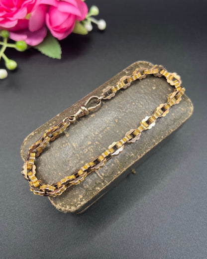 A fancy link yellow gold bracelet with a lobster claw clasp