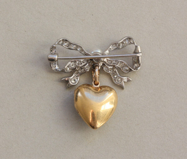 Antique Edwardian Diamond and Pearl Bow and Heart Locket Brooch; set with 1.08cts old-cut diamonds and a natural pearl, platinum and 18ct gold