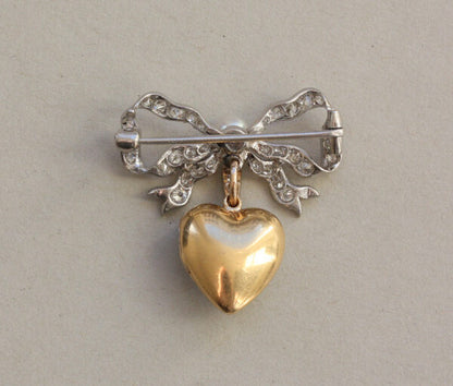 Antique Edwardian Diamond and Pearl Bow and Heart Locket Brooch; set with 1.08cts old-cut diamonds and a natural pearl, platinum and 18ct gold
