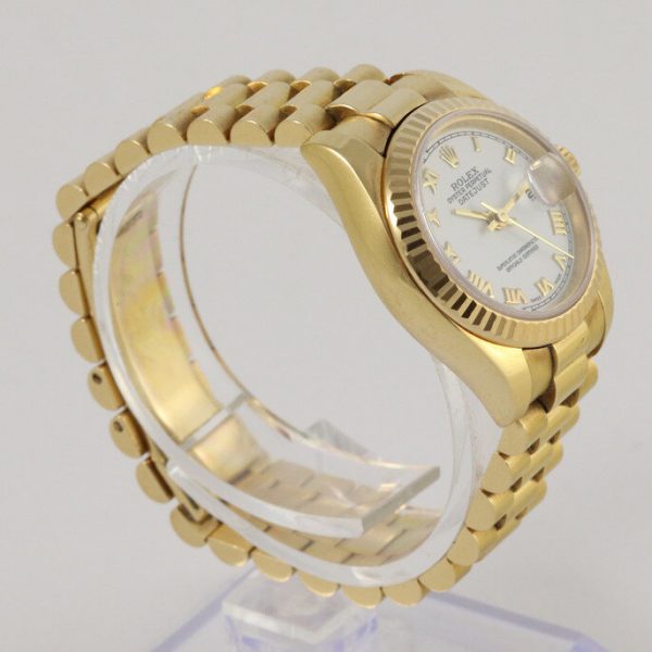 Rolex Lady Datejust 18ct Yellow Gold 179178 Automatic Watch; white dial, Roman numerals, date indicator and sapphire crystal, 18ct yellow gold President bracelet with 18ct yellow gold Crownclasp, with Rolex box and papers.