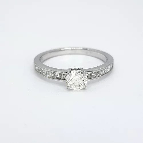 Diamond Solitaire Engagement Ring with Princess Cut Shoulders; central 0.52 carat round brilliant-cut diamond, four-claw set, flanked by 0.43cts channel-set princess-cut diamond set shoulders, in 18ct white gold