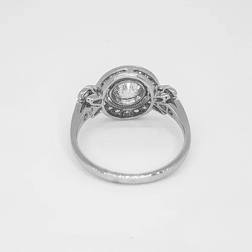 Diamond and Platinum Cluster Dress Ring; central 0.75 carat round brilliant-cut diamond surrounded by diamond halo border and diamond set shoulders, 1.10 carat total