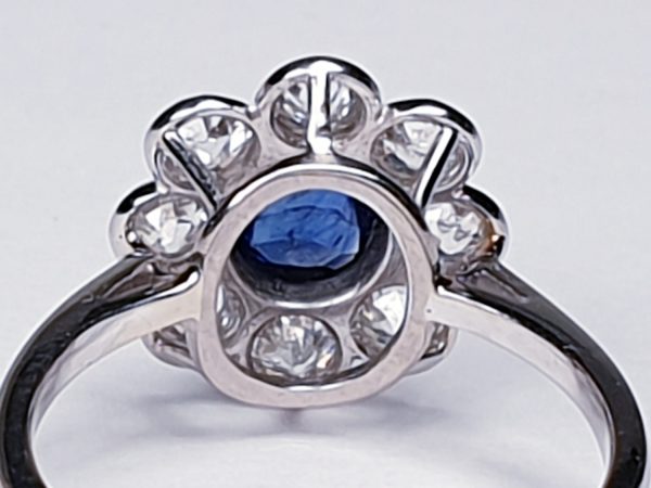 Vintage Sapphire and Old Cut Diamond Flower Cluster Ring; central 0.75 carat natural royal blue sapphire surrounded by 1.40cts old cut diamonds, on a new platinum shank