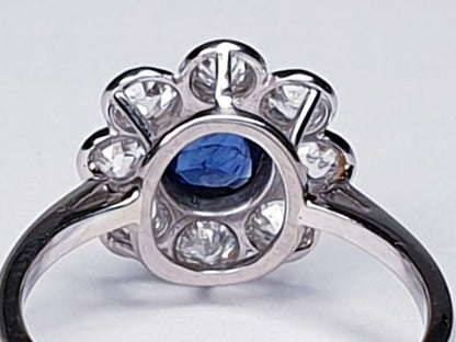 Vintage Sapphire and Old Cut Diamond Flower Cluster Ring; central 0.75 carat natural royal blue sapphire surrounded by 1.40cts old cut diamonds, on a new platinum shank