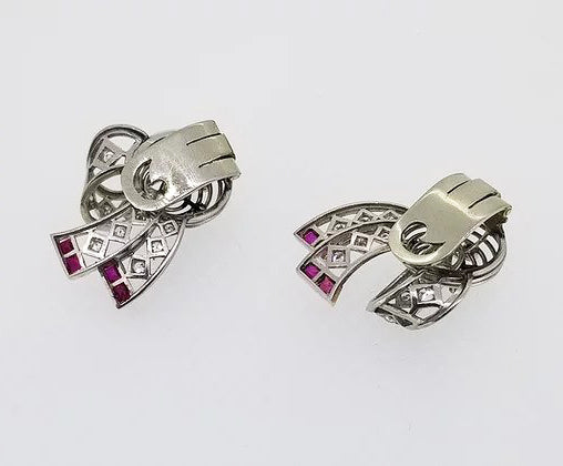 Vintage Diamond, Platinum and Ruby Clip On Earrings, openwork bow design, set with diamonds throughout and accented with rubies. Circa 1940.