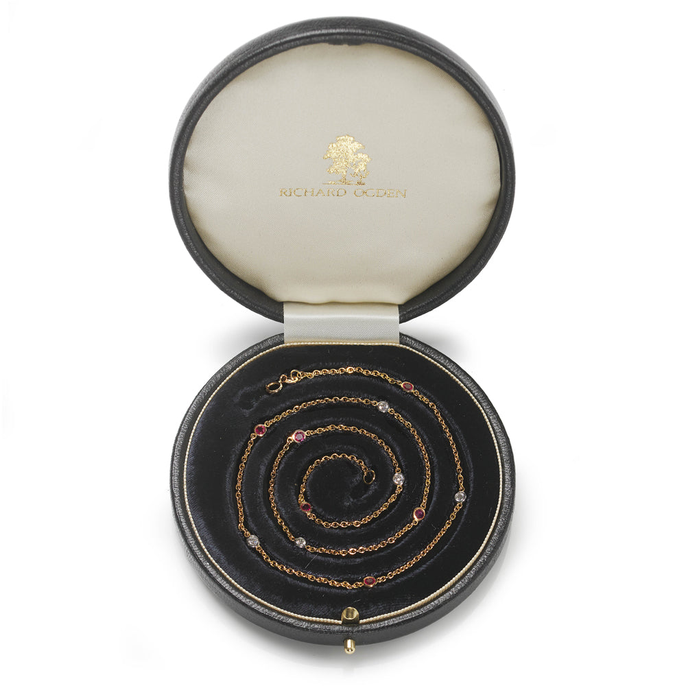 18ct yellow gold necklace set with alternating brilliant cut diamonds and Burma rubies.