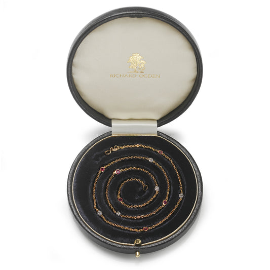 18ct yellow gold necklace set with alternating brilliant cut diamonds and Burma rubies.