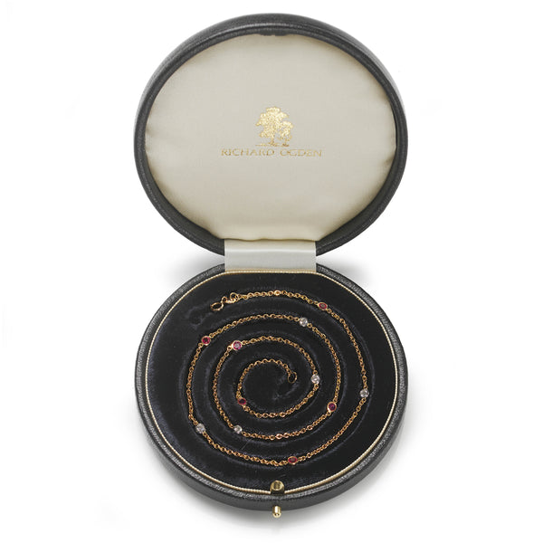 18ct yellow gold necklace set with alternating brilliant cut diamonds and Burma rubies.