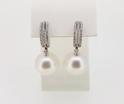 Pearl and Diamond Drop Earrings; featuring 14mm pearls suspended from diamond set hoops, 0.60 carat total, mounted in 18ct white gold.