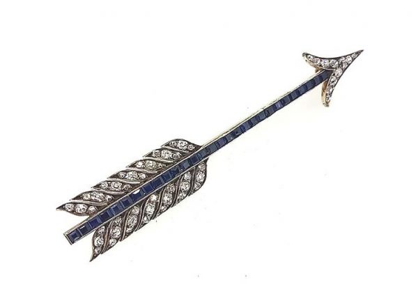 Vintage Sapphire and Diamond Set Arrow Brooch; The main body set with calibre-cut sapphires, diamond set arrow head and feathers, crafted in 18ct white gold