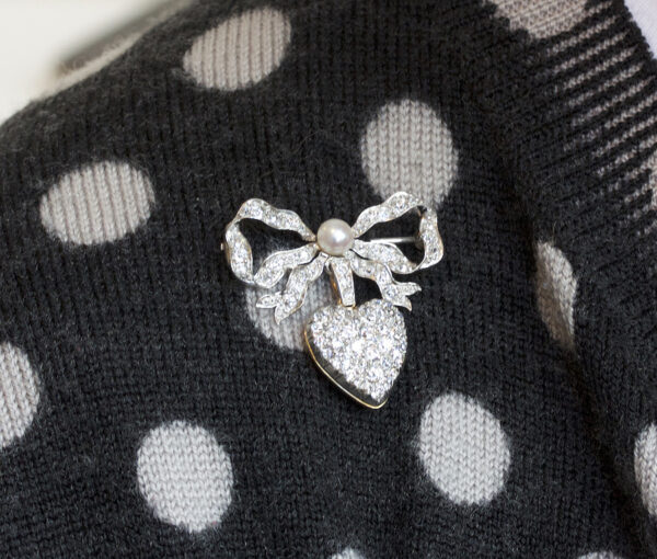 Antique Edwardian Diamond and Pearl Bow and Heart Locket Brooch; set with 1.08cts old-cut diamonds and a natural pearl, platinum and 18ct gold