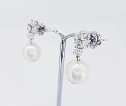 South Sea Pearl and Diamond Drop Earrings; featuring 11mm white South Sea pearls suspended from 1.16cts diamond clusters, in 18ct white gold