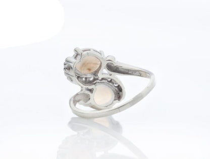 Vintage 1.50ct Opal and Diamond Crossover Ring; set with two opals enveloped by 0.18cts diamonds, 14ct white gold, Circa 1960s