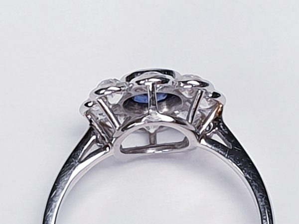 Vintage Sapphire and Old Cut Diamond Flower Cluster Ring; central 0.75 carat natural royal blue sapphire surrounded by 1.40cts old cut diamonds, on a new platinum shank