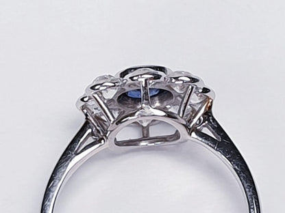 Vintage Sapphire and Old Cut Diamond Flower Cluster Ring; central 0.75 carat natural royal blue sapphire surrounded by 1.40cts old cut diamonds, on a new platinum shank