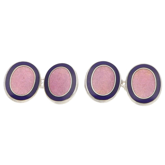 Pair of pink and navy oval silver cufflinks on a white background