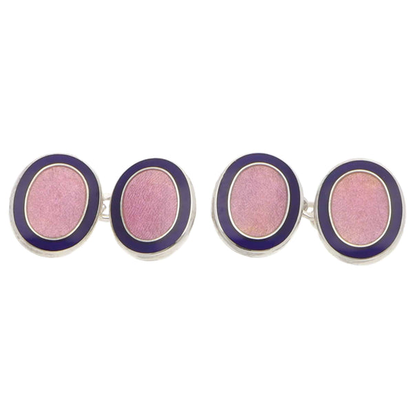 Pair of pink and navy oval silver cufflinks on a white background