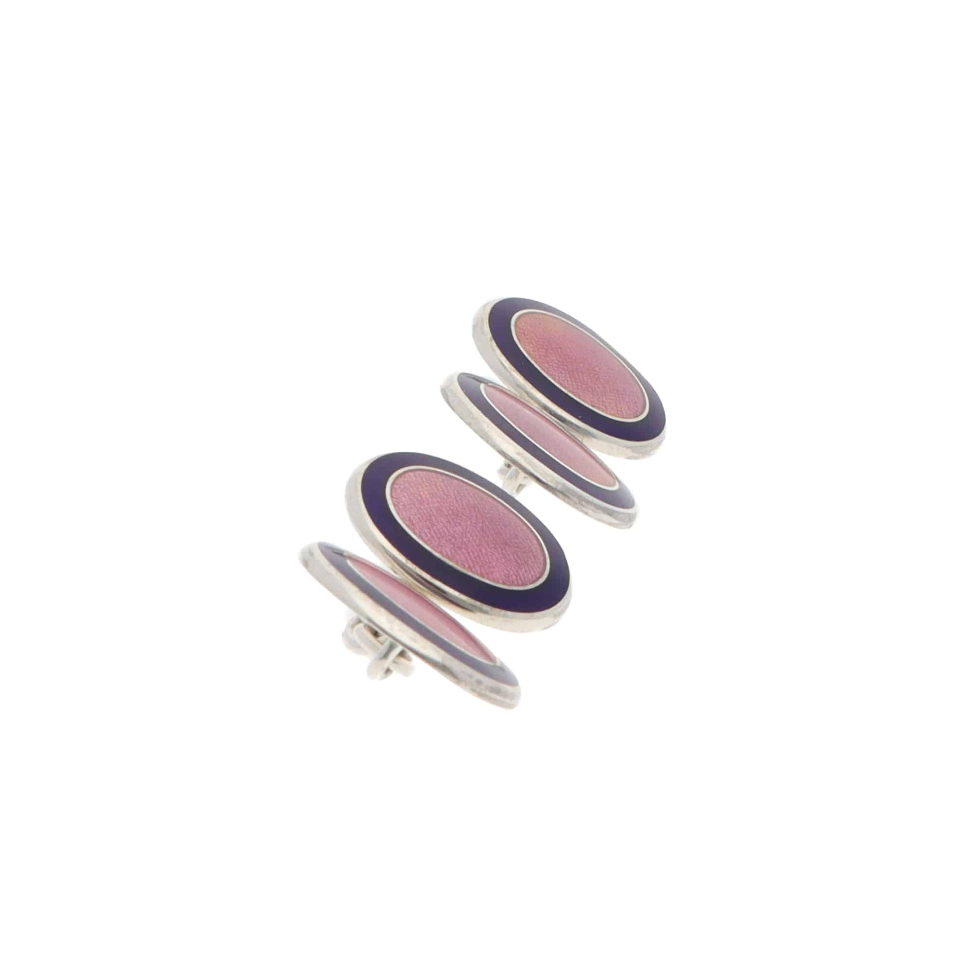 Pair of pink and navy oval silver cufflinks on a white background