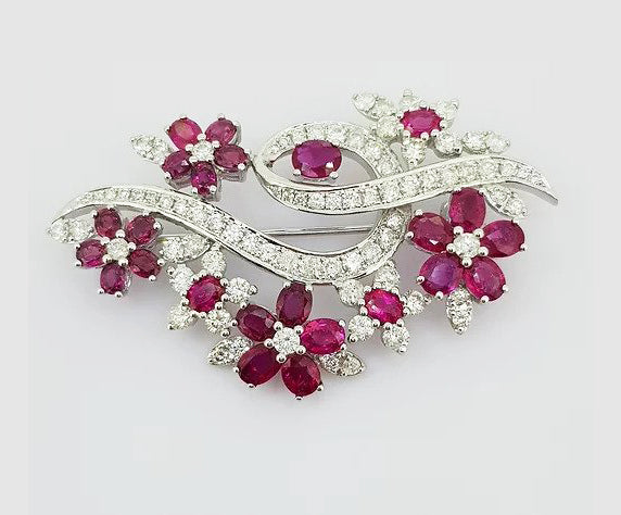 Vintage 1970s Ruby and Diamond Floral Spray Brooch; set with oval faceted rubies and brilliant-cut diamonds. Crafted from 18ct white gold. Circa 1970.