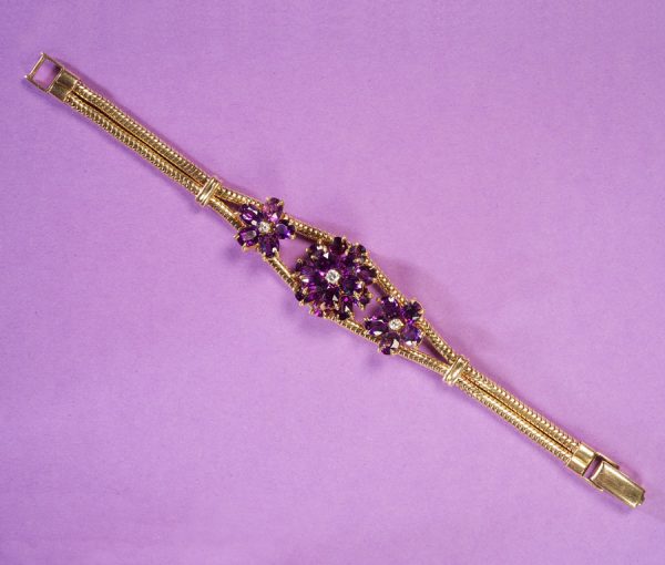 Vintage 1950s Amethyst and Diamond Flower Set Bracelet; 14ct yellow gold ropework bracelet with three amethyst flowers with diamond centres