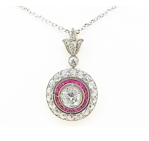 Diamond and Ruby Target Cluster Pendant, 5cts, brilliant-cut diamond surrounded by calibre-cut rubies and diamonds, diamond-set fleur-de-lis bale, 18ct white gold
