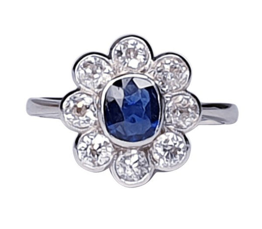 Vintage Sapphire and Old Cut Diamond Flower Cluster Ring; central 0.75 carat natural royal blue sapphire surrounded by 1.40cts old cut diamonds, on a new platinum shank