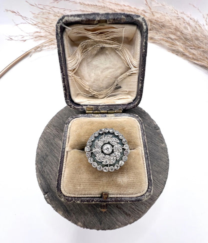 A diamond and dark blue enamel fancy cluster ring in white gold, in an antique ring box