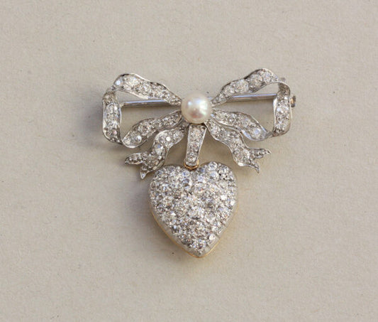 Antique Edwardian Diamond and Pearl Bow and Heart Locket Brooch; set with 1.08cts old-cut diamonds and a natural pearl, platinum and 18ct gold