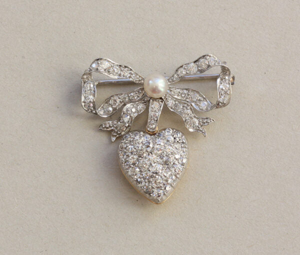 Antique Edwardian Diamond and Pearl Bow and Heart Locket Brooch; set with 1.08cts old-cut diamonds and a natural pearl, platinum and 18ct gold