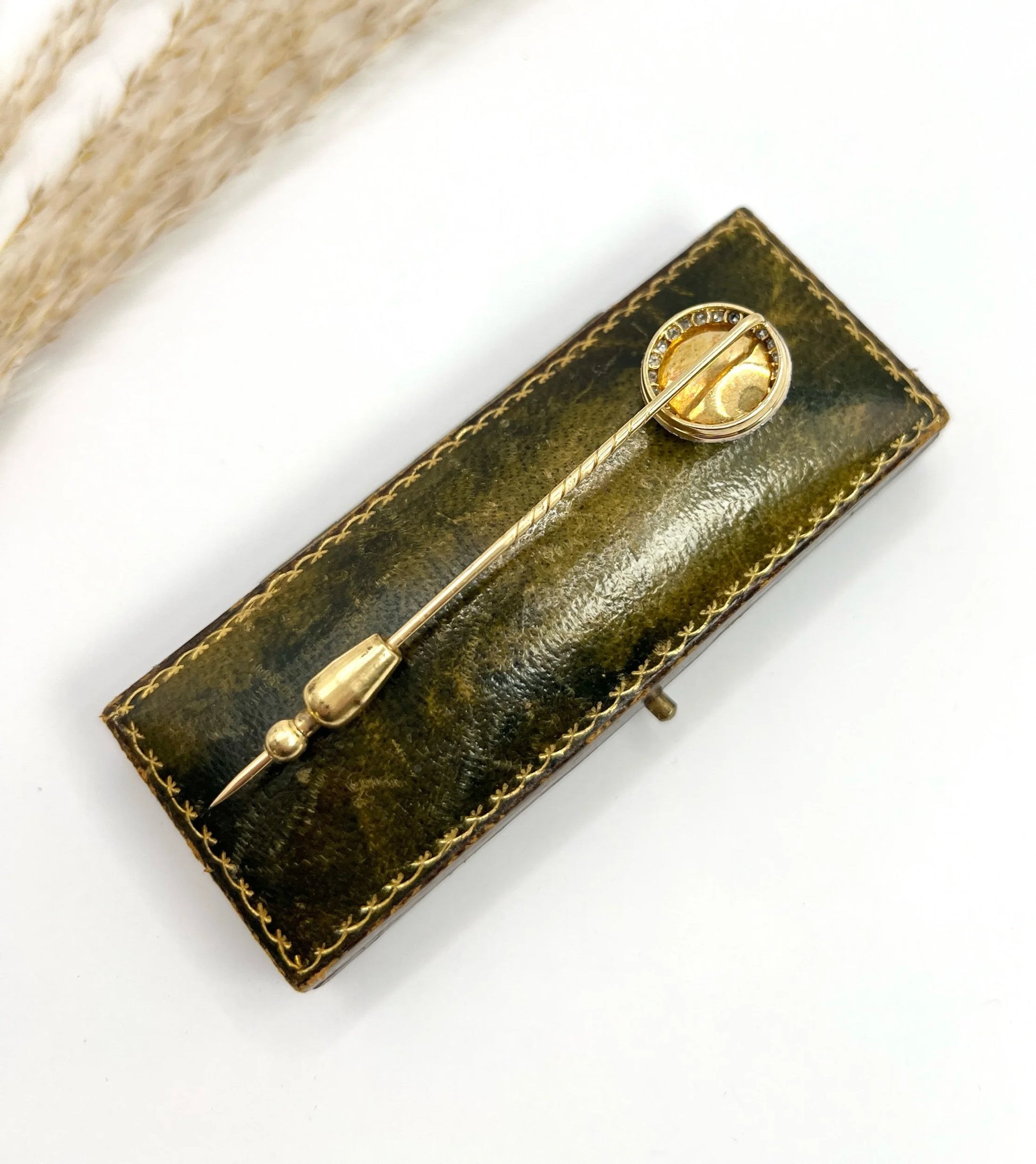 An antique Essex glass and diamond stick pin depicting a jockey riding a horse, on a box