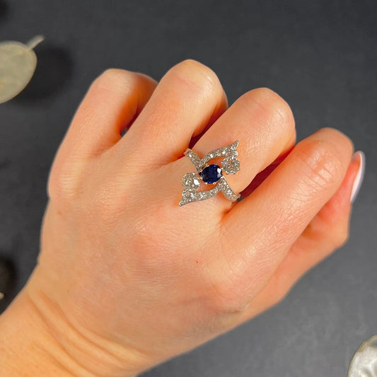 A navette shaped sapphire and diamond cluster ring, modelled on a hand