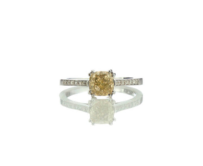 Fancy Yellow Diamond Engagement Ring, 1.24 carat cushion-cut fancy yellow diamond, double four-claw set and accented with diamond set shoulders. Circa 1990s. Fully hallmarked. Comes with AIG certificate.