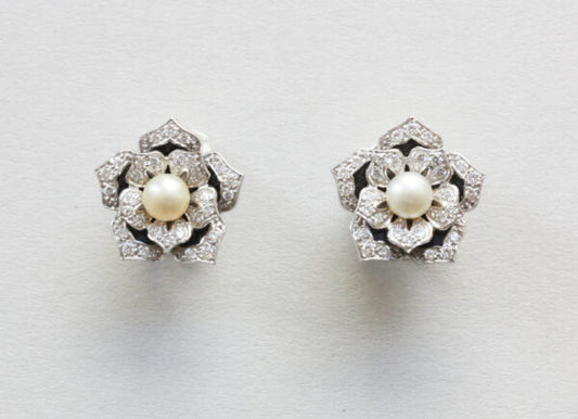 Diamond, Pearl and Enamel Lotus Flower Stud Earrings; pearl surrounded by diamond set leaves, enamel detailing, 14ct gold. Steltman, Netherlands, 2004