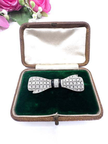 Art Deco 14 Carat White Gold Onyx and Diamond Bow Brooch, Circa 1920