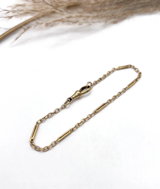 A yellow gold link bracelet with a lobster claw clasp
