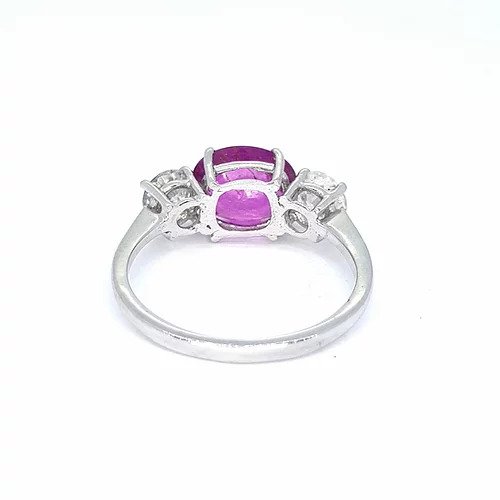 Pink Sapphire and Diamond Three Stone Ring; 2.30ct oval cut pink sapphire flanked by 0.97cts brilliant cut diamonds, in 18ct white gold