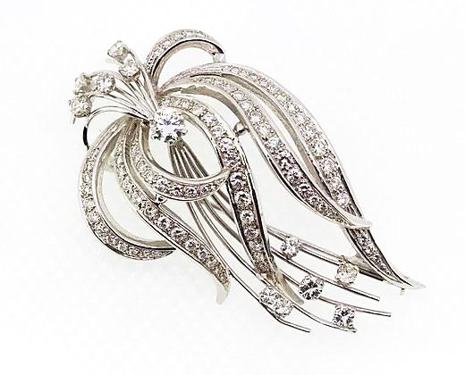 Vintage 1950's Diamond Spray Brooch; A striking spray brooch reminiscent of foliage, round cut diamonds studding the moving lines, high carat white gold