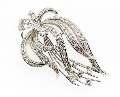 Vintage 1950's Diamond Spray Brooch; A striking spray brooch reminiscent of foliage, round cut diamonds studding the moving lines, high carat white gold