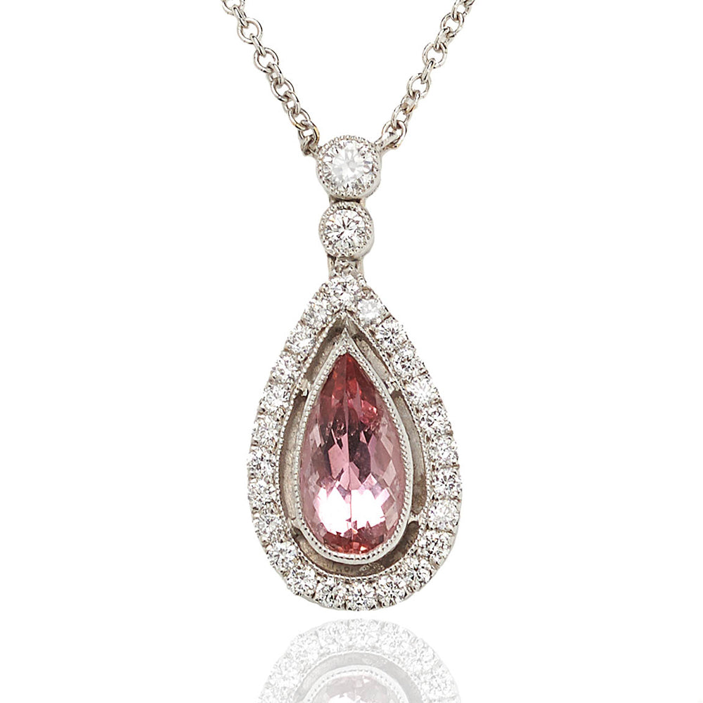 Topaz and diamond cluster drop pendant set in 18 carat white gold.