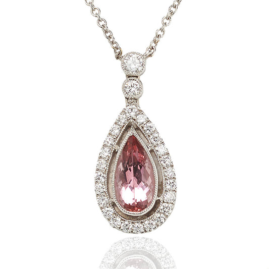 Topaz and diamond cluster drop pendant set in 18 carat white gold.