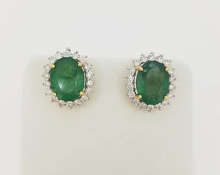 Emerald and Diamond Oval Cluster Stud Earrings; featuring 5.07cts oval faceted emeralds surrounded by 0.84cts brilliant diamonds, 18ct gold