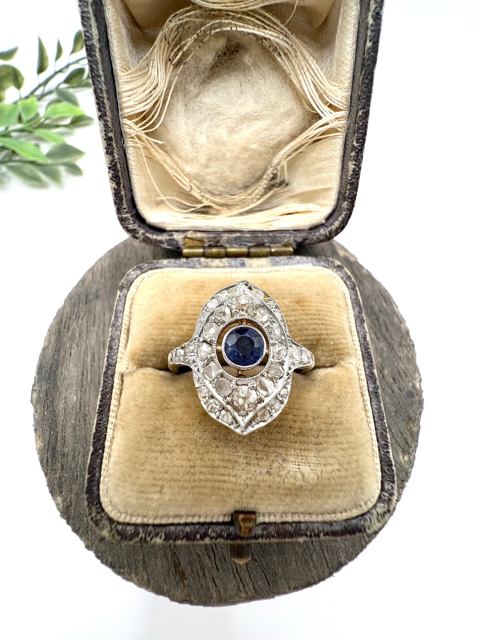 A sapphire and diamond openwork ring in platinum with a yellow gold ring shank, in an antique ring box